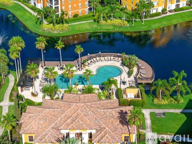 A large house with a pool and a waterfall in front of it.