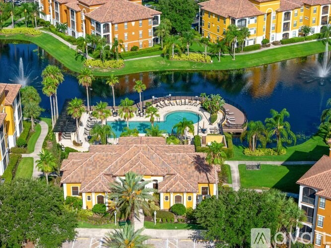 A large building with a pool in front of it.