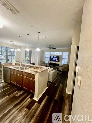 A kitchen with wooden floors and a large island.