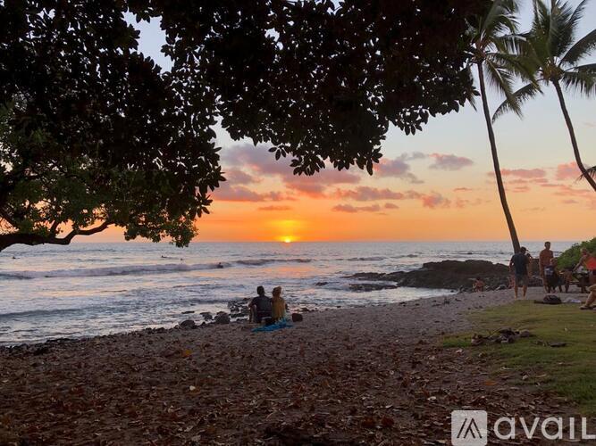 A beautiful beach scene with people enjoying the sunset.