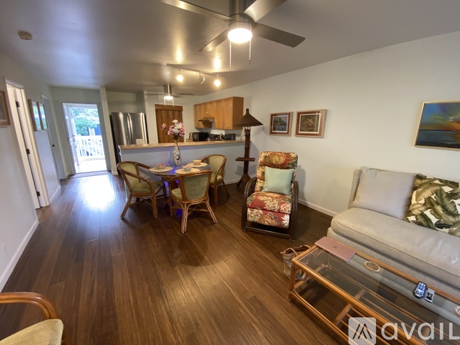 A living room with a couch, chairs, and a coffee table.
