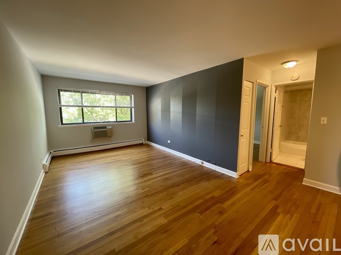 A room with wooden floors and a window.