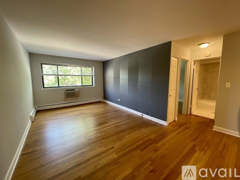 A room with wooden floors and a window.