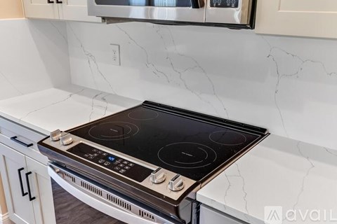 A modern kitchen with a black stove top oven.