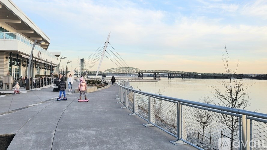 A group of people are walking on a bridge over a body of water.