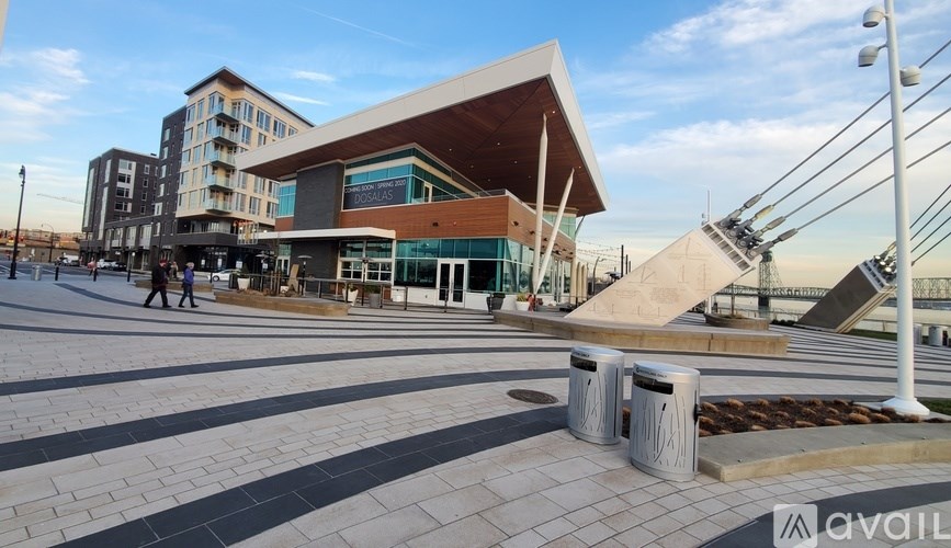 A modern building with a curved roof and a staircase leading up to it.