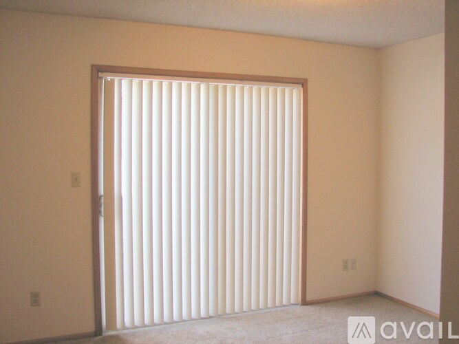 A room with a sliding door and carpeted floor.