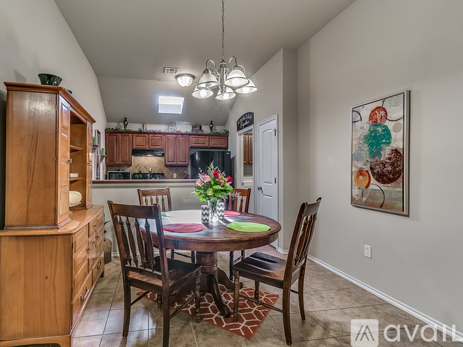 A dining room with a wooden table and chairs.