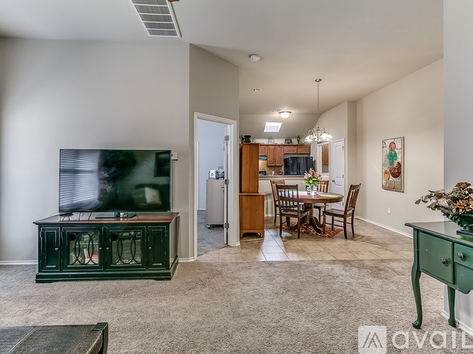 A living room with a green cabinet and a television on the left side.