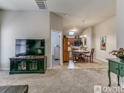 A living room with a green cabinet and a television on the left side.