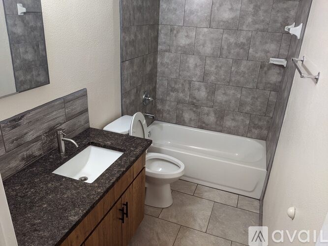 A bathroom with a toilet, sink, and bathtub.