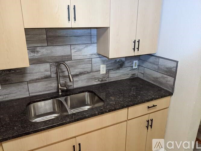 A kitchen with a sink and cabinets.
