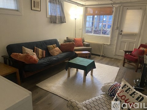 A living room with a blue couch and a green table.