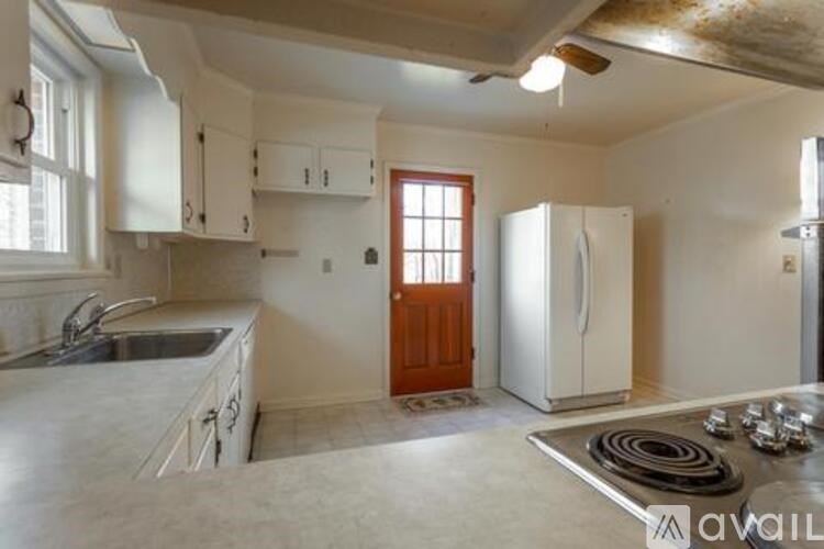 A kitchen with white cabinets and a sink.
