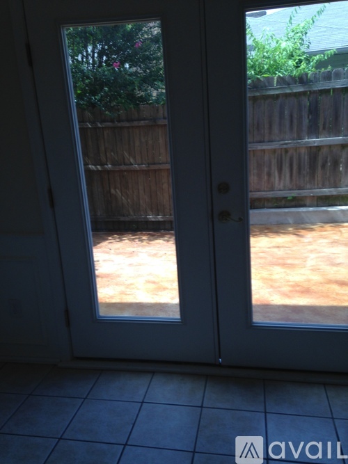 A white door with a glass window is open.