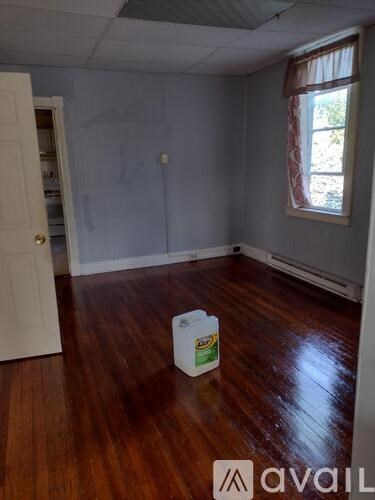 A room with wooden floors and a white door.
