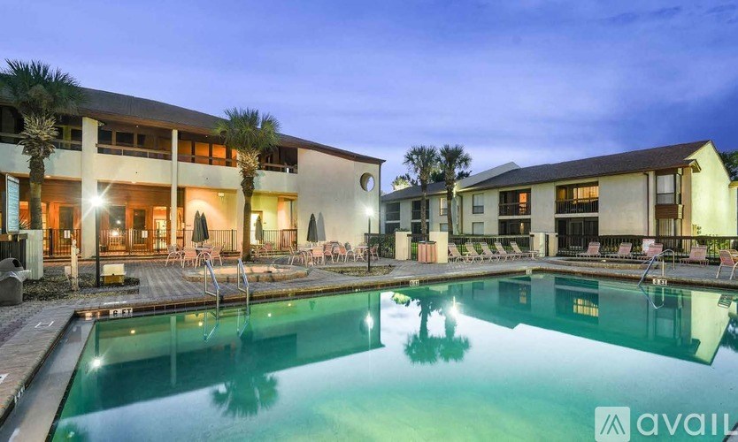 A swimming pool in front of a building with a sign that says "available".