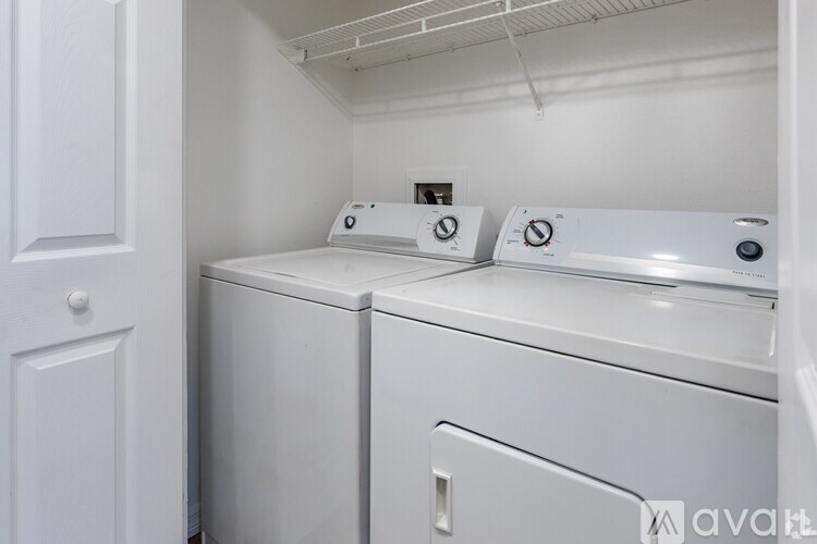 A small laundry room with a washer and dryer.