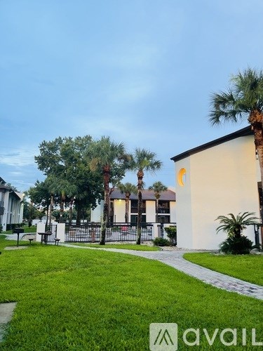 A building with a white wall and a yellow logo on it.