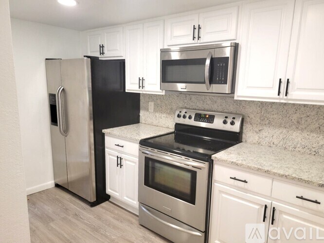 A kitchen with black and stainless steel appliances.