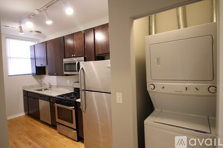 A kitchen with a stainless steel refrigerator and a dishwasher.