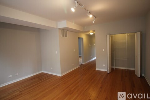 A room with wooden floors and a wall-mounted mirror.