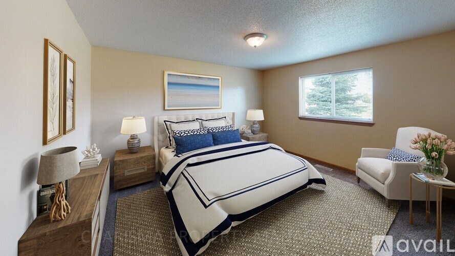 A bedroom with a large bed and a chair.