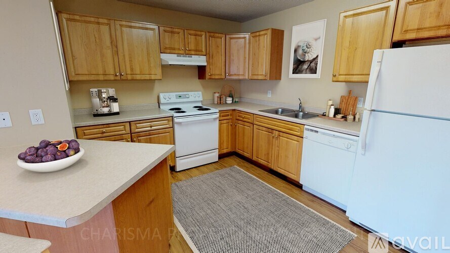 A kitchen with wooden cabinets and a white refrigerator.