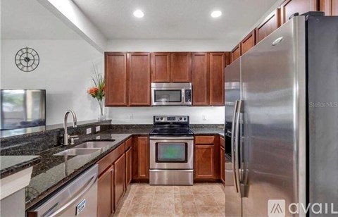 A kitchen with wooden cabinets and stainless steel appliances.