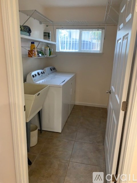 A small kitchen with a white stove top oven and a white dishwasher.