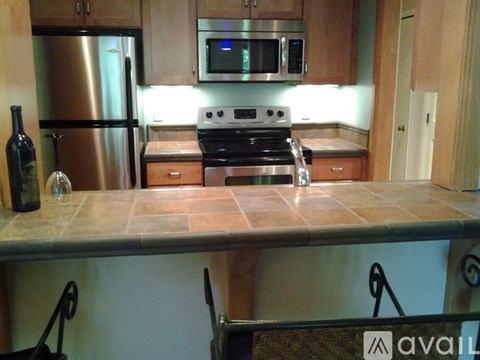A kitchen with a stove top oven and a microwave above it.