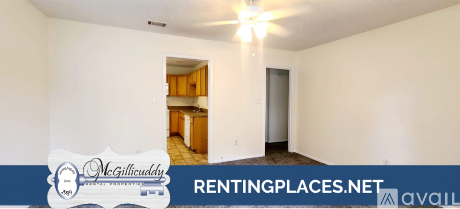 A room with a window and a carpeted floor is available for rent.