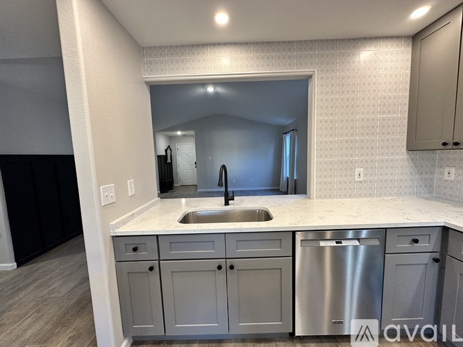 A kitchen with a sink and a mirror.