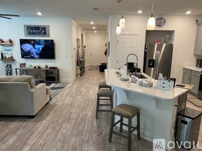 A modern kitchen with a bar stool and a countertop.