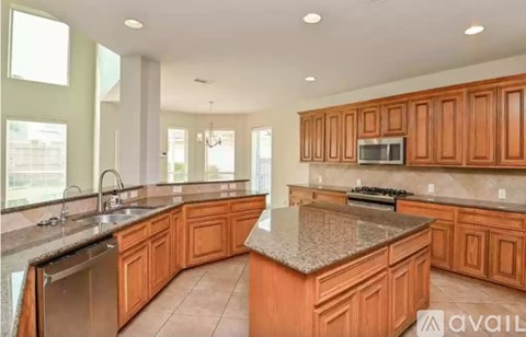 A kitchen with wooden cabinets and granite countertops.