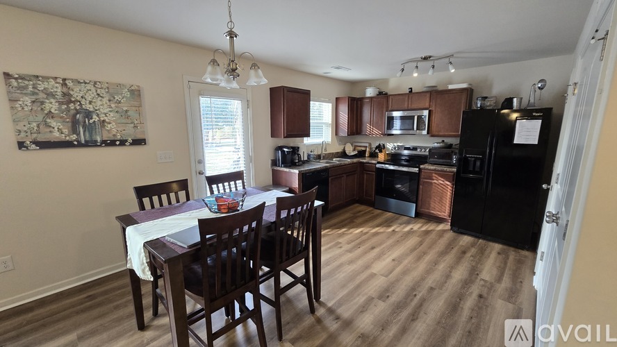 A kitchen with a table and chairs in the middle of the room.