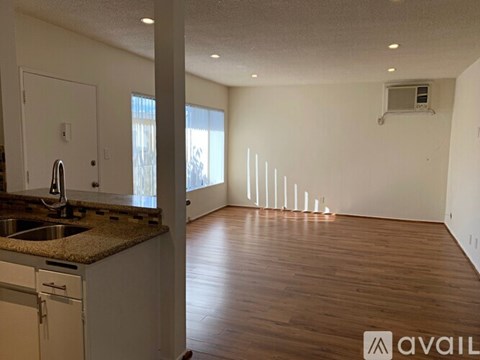 A kitchen with a sink and a countertop is available for rent.