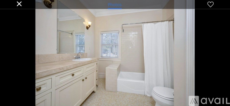 A bathroom with a toilet, sink, and bathtub.