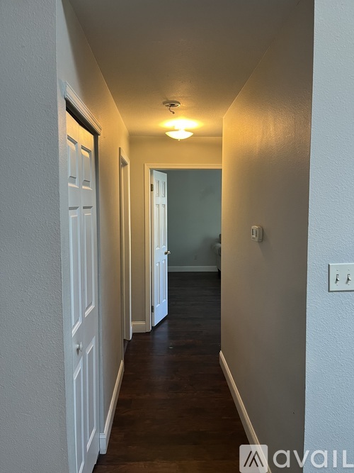 A bedroom with a bed and a wall hanging.