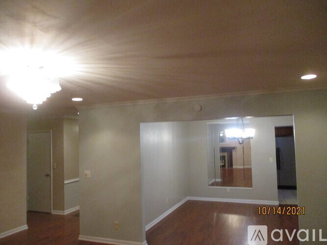 A room with a wooden floor and a ceiling light.