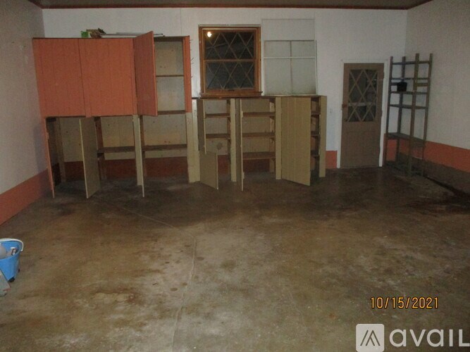 A room with a window, a door, and a table with chairs.