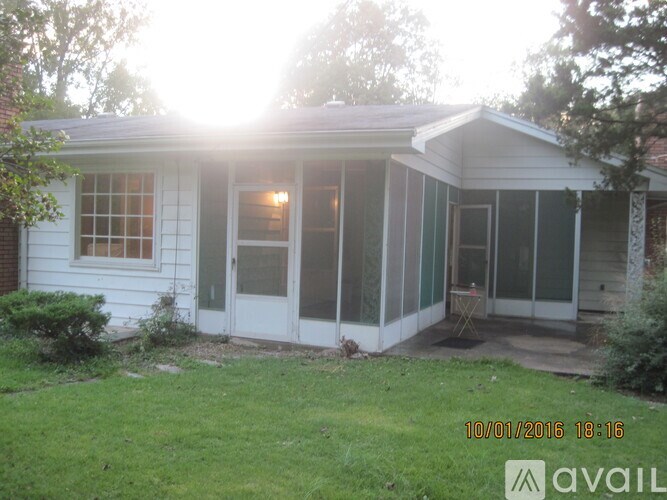 A house with a white door and windows is shown in the image.