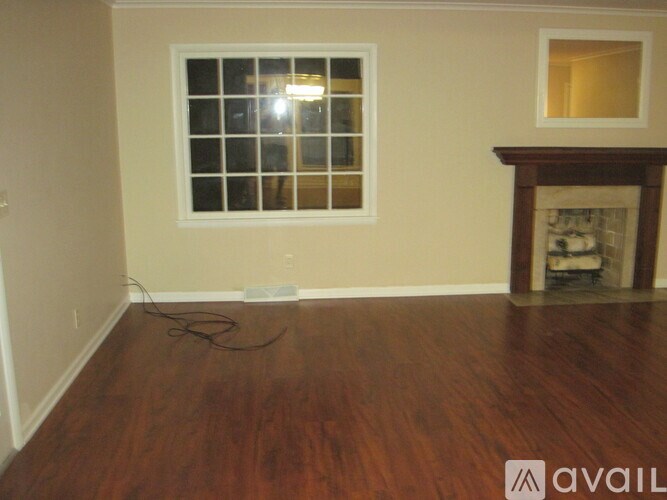 A room with a fireplace and a window.