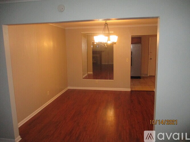 A room with wooden floors and a chandelier.