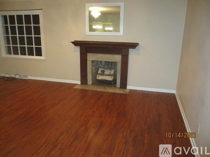 A room with a fireplace and a window.