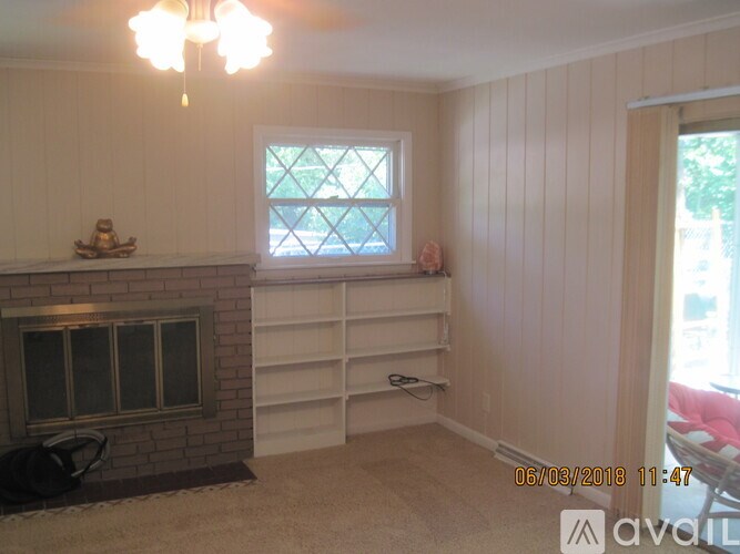 A room with a fireplace and a window.