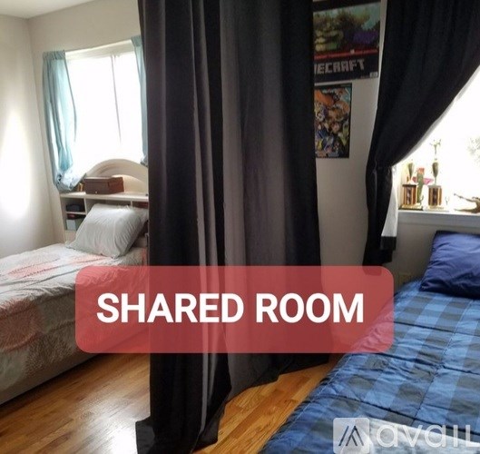 A bedroom with a bed and a poster on the wall.