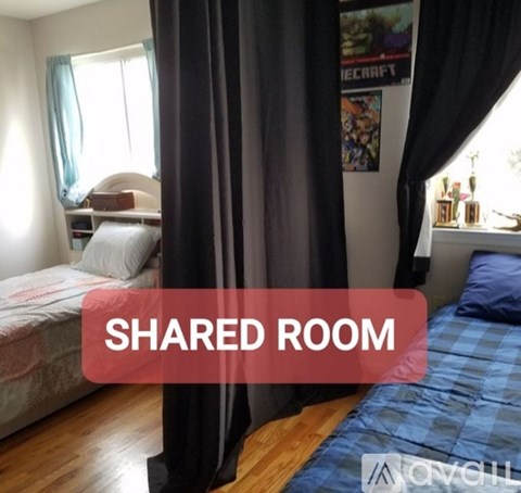 A bedroom with a bed and a poster on the wall.