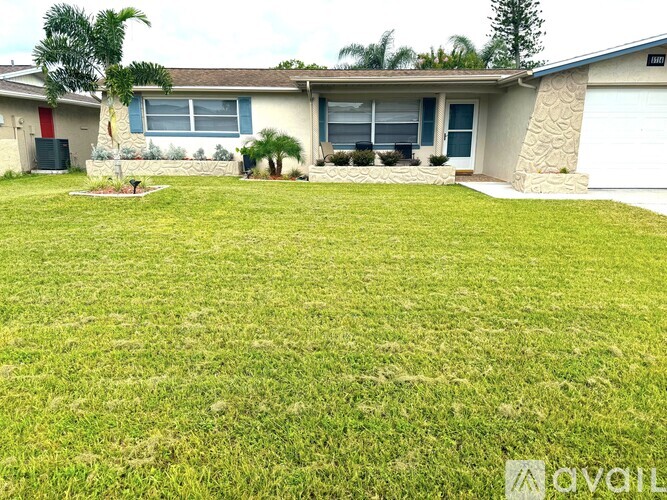 A house with a large lawn in front.