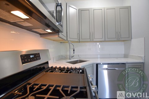 A modern kitchen with a stove top and a dishwasher.